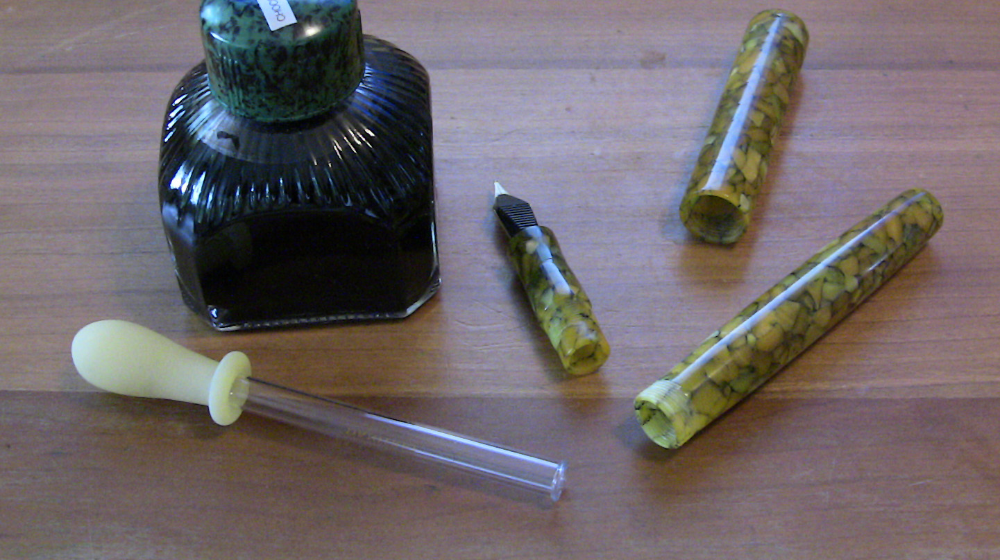 Edison Huron separated from cap and section next to ink bottle and glass eyedropper for filling the pen with ink Alt text
